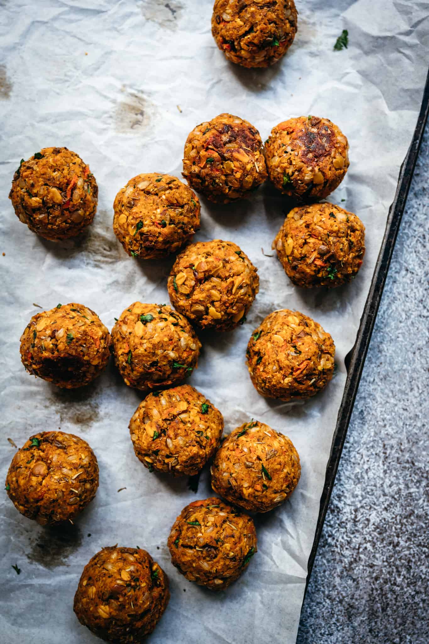 overhead view of homemade vegan lentil meatballs on sheet pan