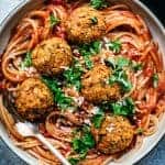 overhead closeup of veganf lentil meatballs on spaghetti with tomato sauce