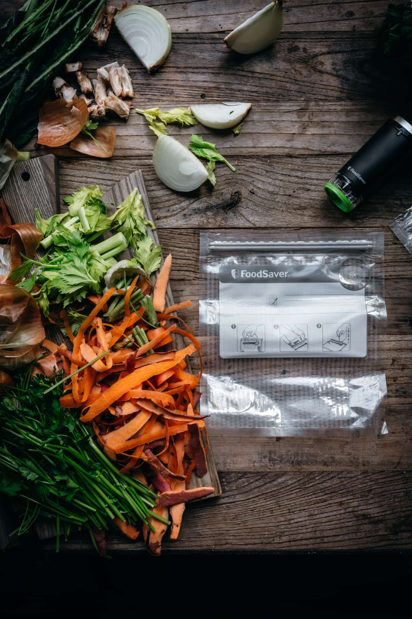 overhead view of FoodSaver vacuum sealer next to cutting tray with vegetable scraps