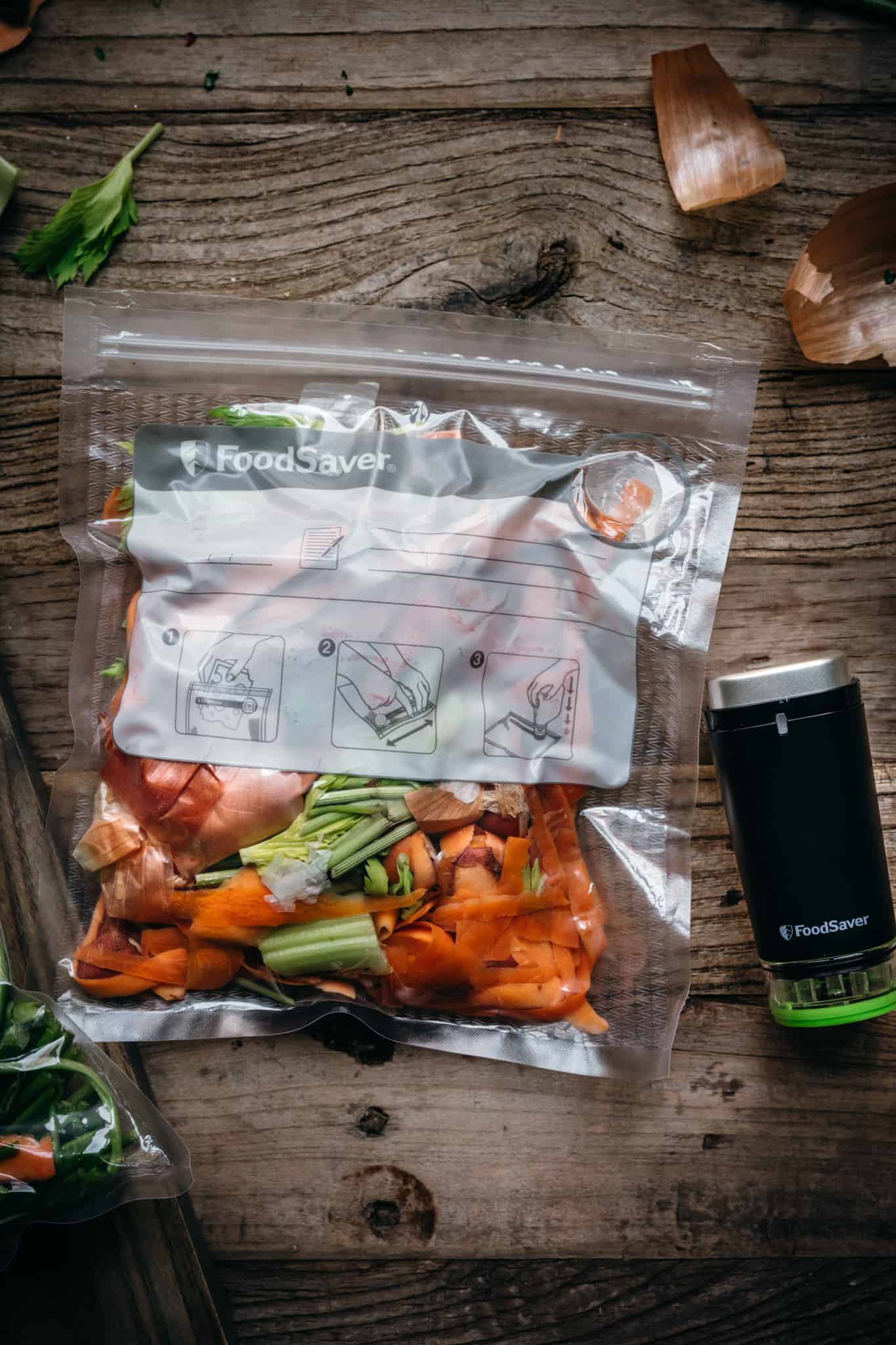 overhead view of vegetable scraps in vacuum sealed plastic bag