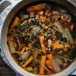 overhead view of cooked homemade vegetable broth in a large pot