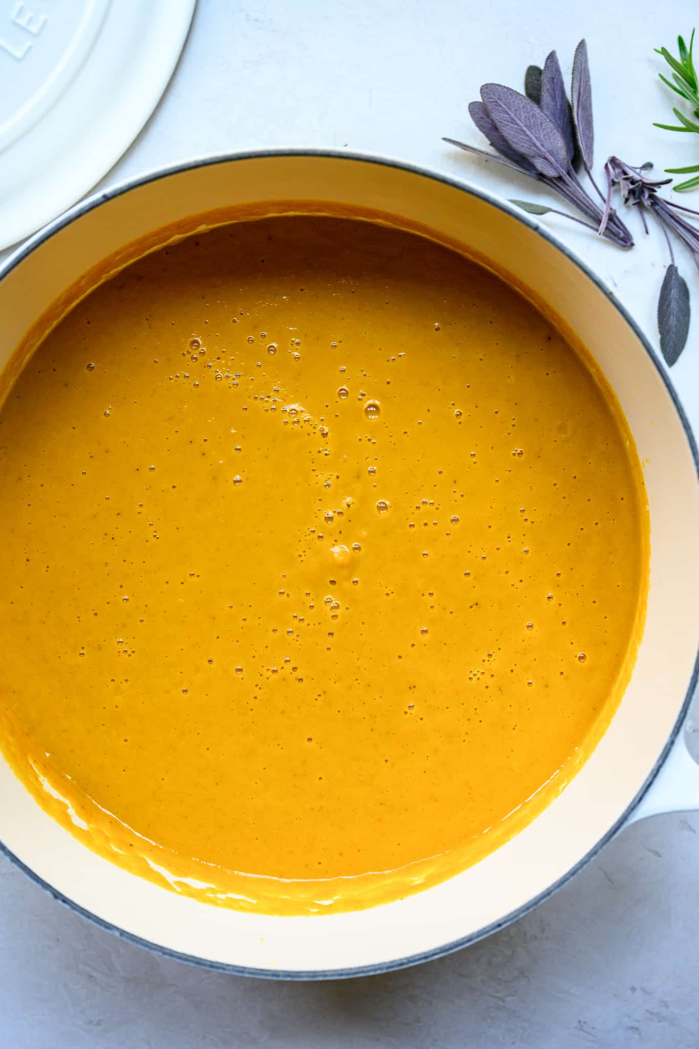 overhead view of pureed carrot vegan soup in white pot