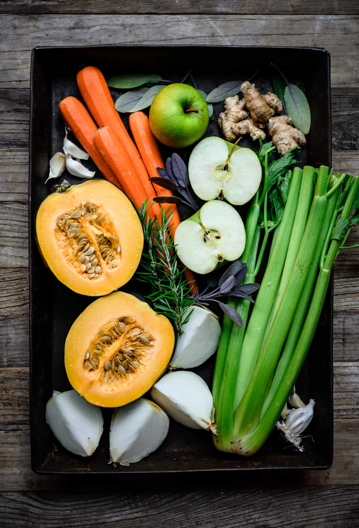 overhead view of produce ingredients for vegan carrot apple ginger soup