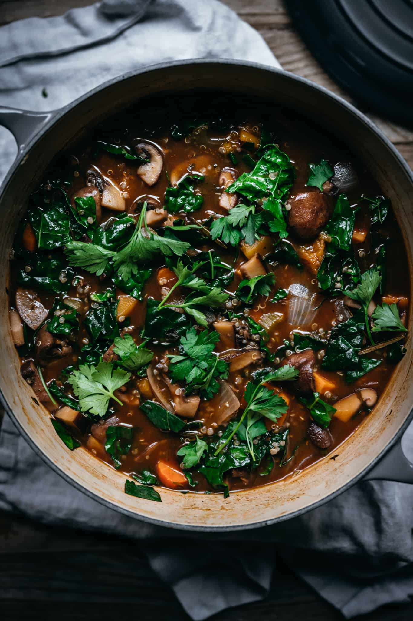 overhead of vegetable quinoa mushroom stew in a large dutch oven