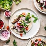 overhead view of vegan mushroom shawarma on pita with vegetarian toppings