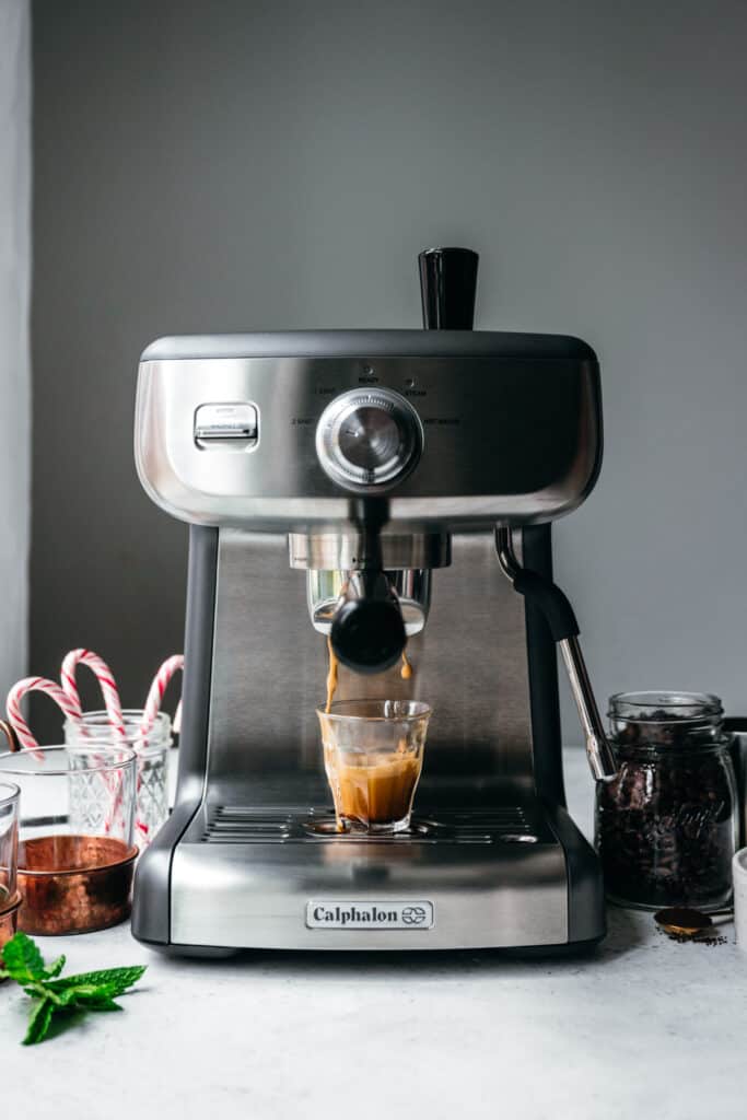 Action shot of espresso going into small mug