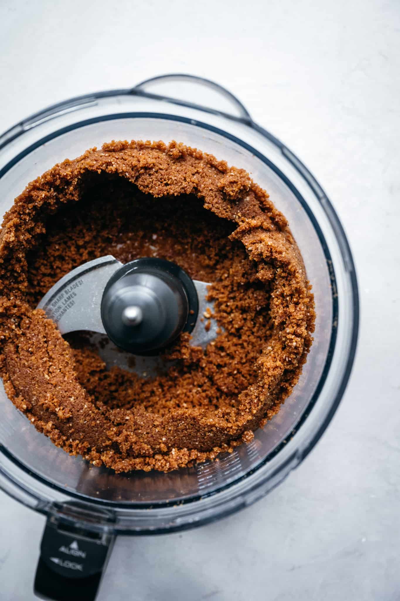 Overhead view of gluten free gingersnap pie crust in food processor