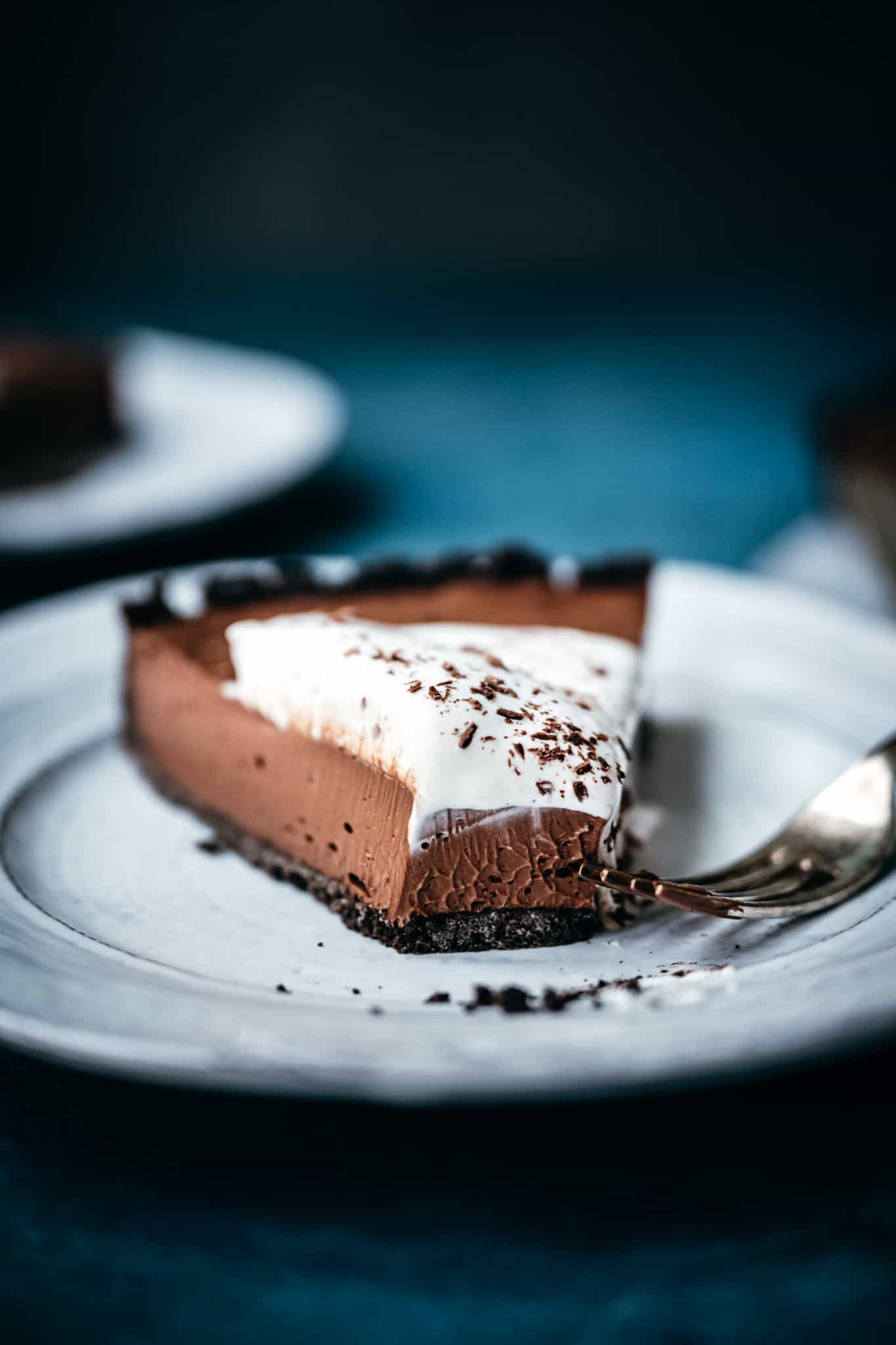 close up side view of texture of vegan chocolate cream pie on white plate