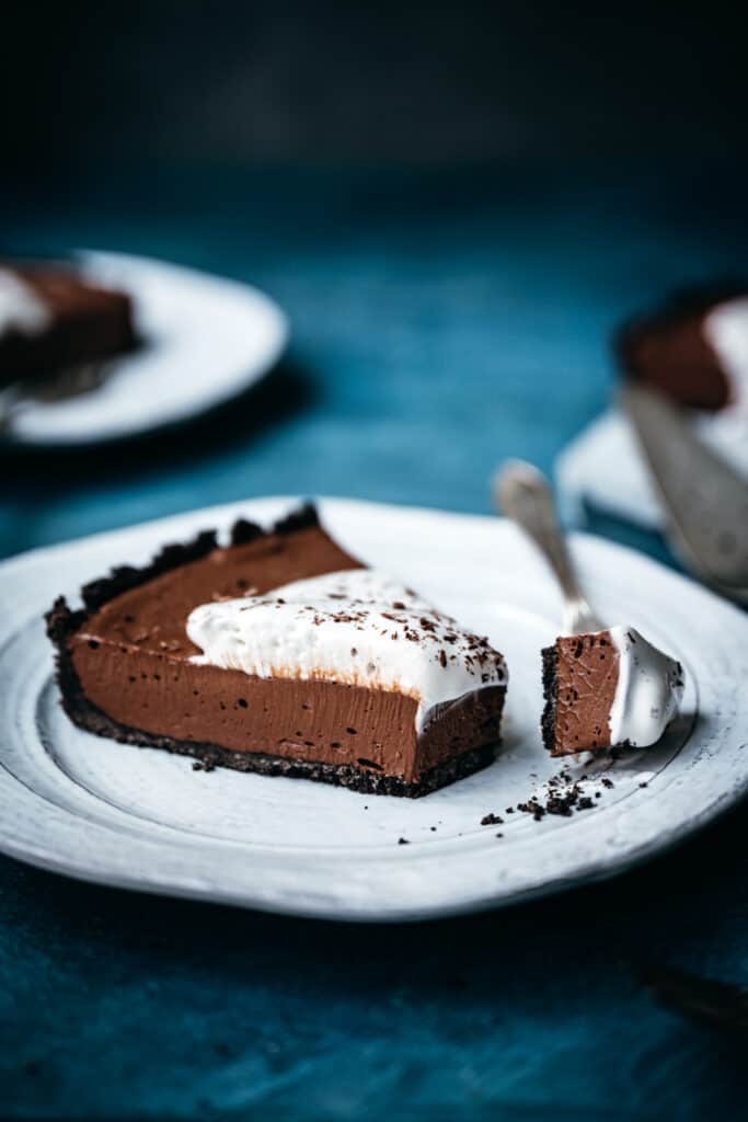side view of slice of chocolate cream pie with fork