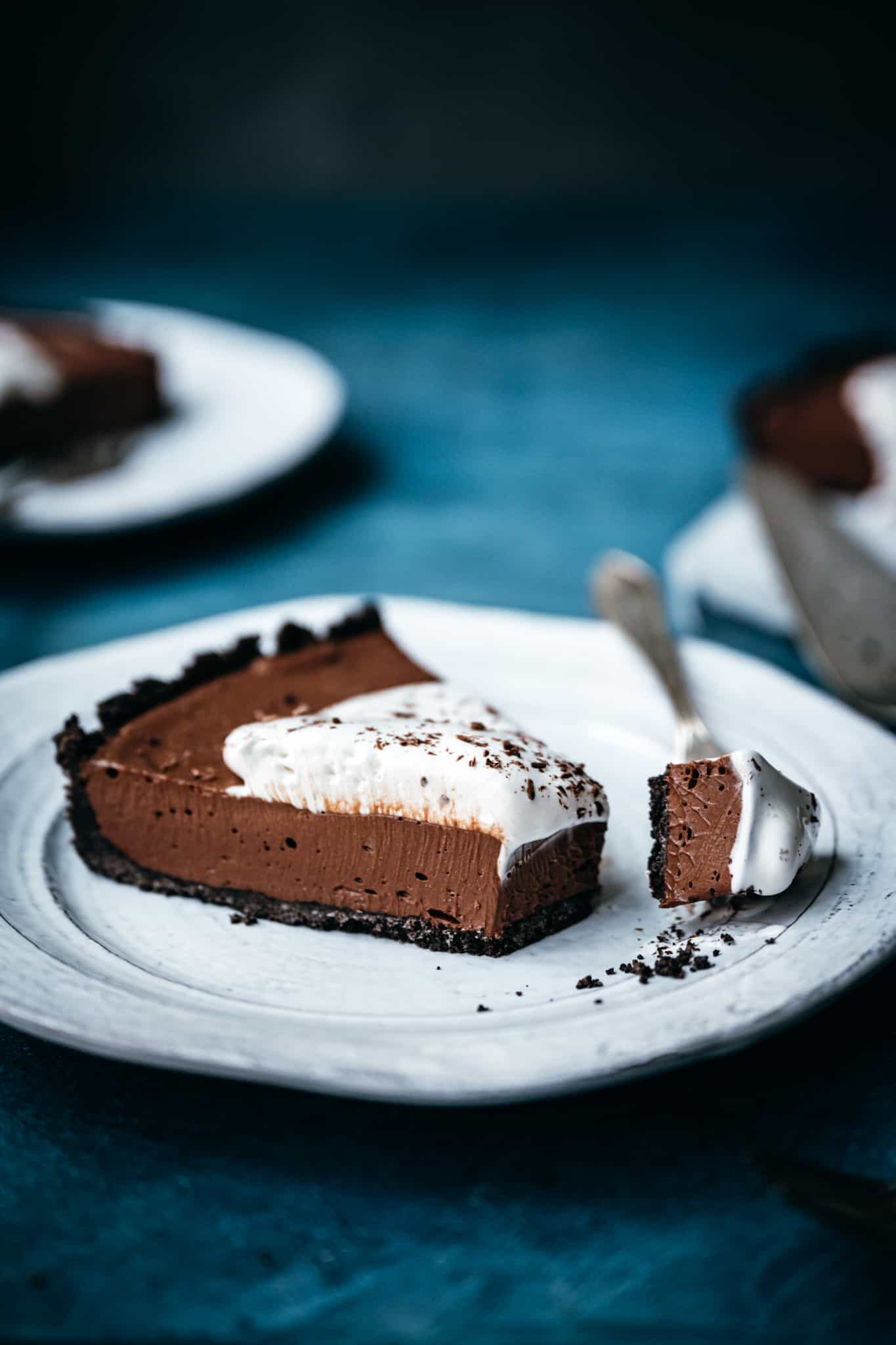 side view of slice of chocolate cream pie with fork