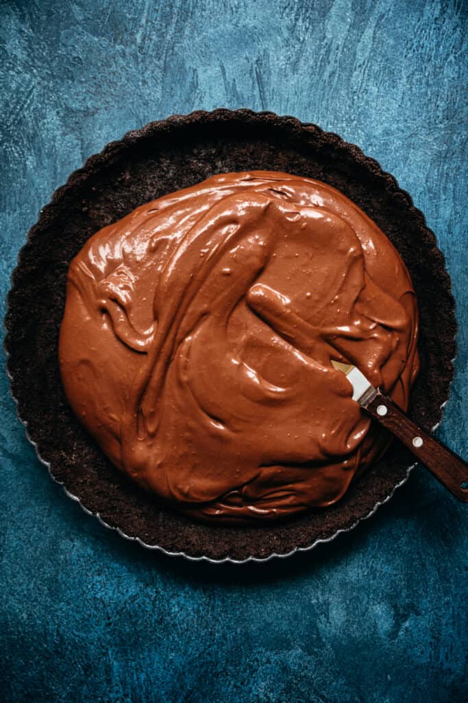 overhead view of vegan chocolate pie filling in cookie crust
