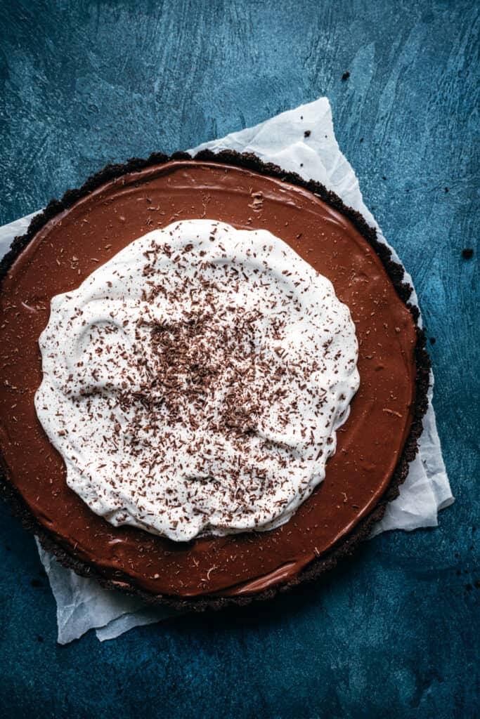 overhead view of whole chocolate pie topped with whipped cream