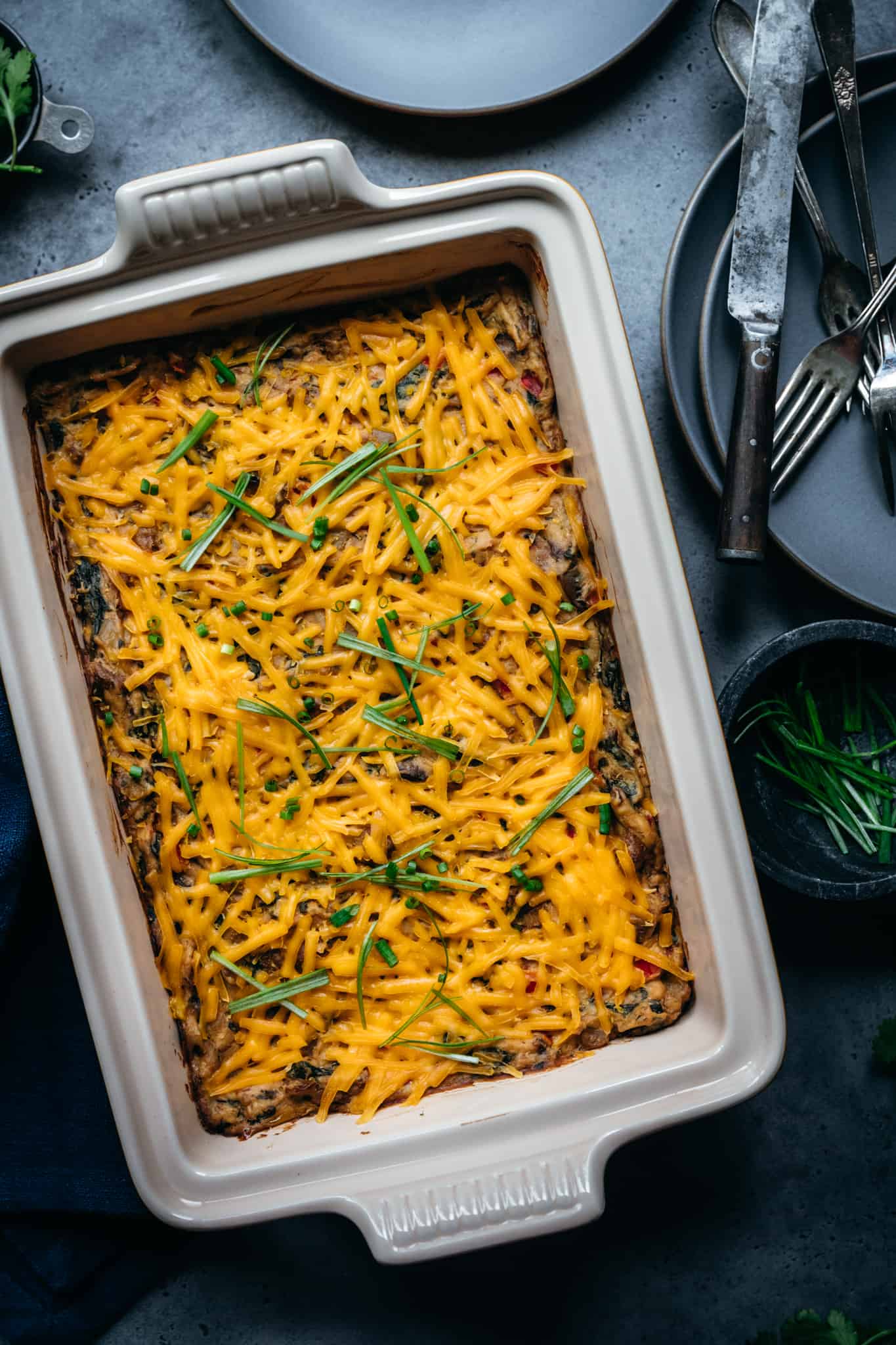 overhead of baked vegan breakfast casserole in a white baking dish