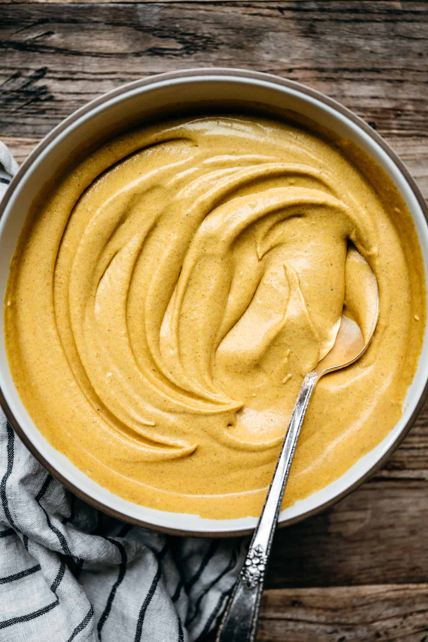 overhead view of mixing bowl with whipped vegan pumpkin mousse in a swirl