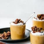 side view of creamy vegan pumpkin mousse in glass jars