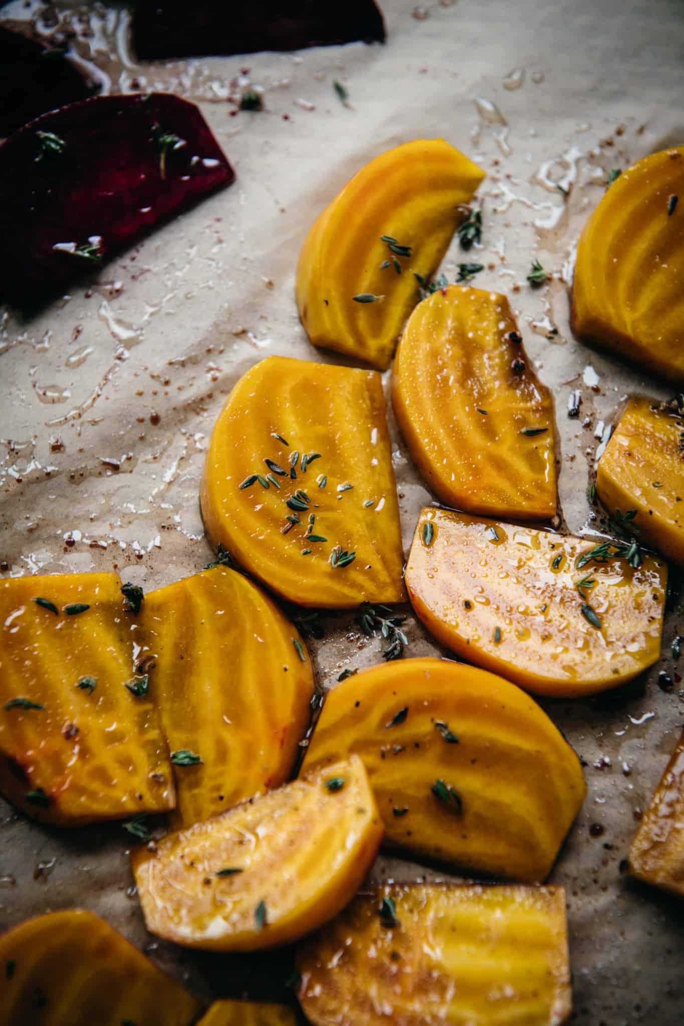 close up side view of golden beets sliced into wedges and drizzled with olive oil