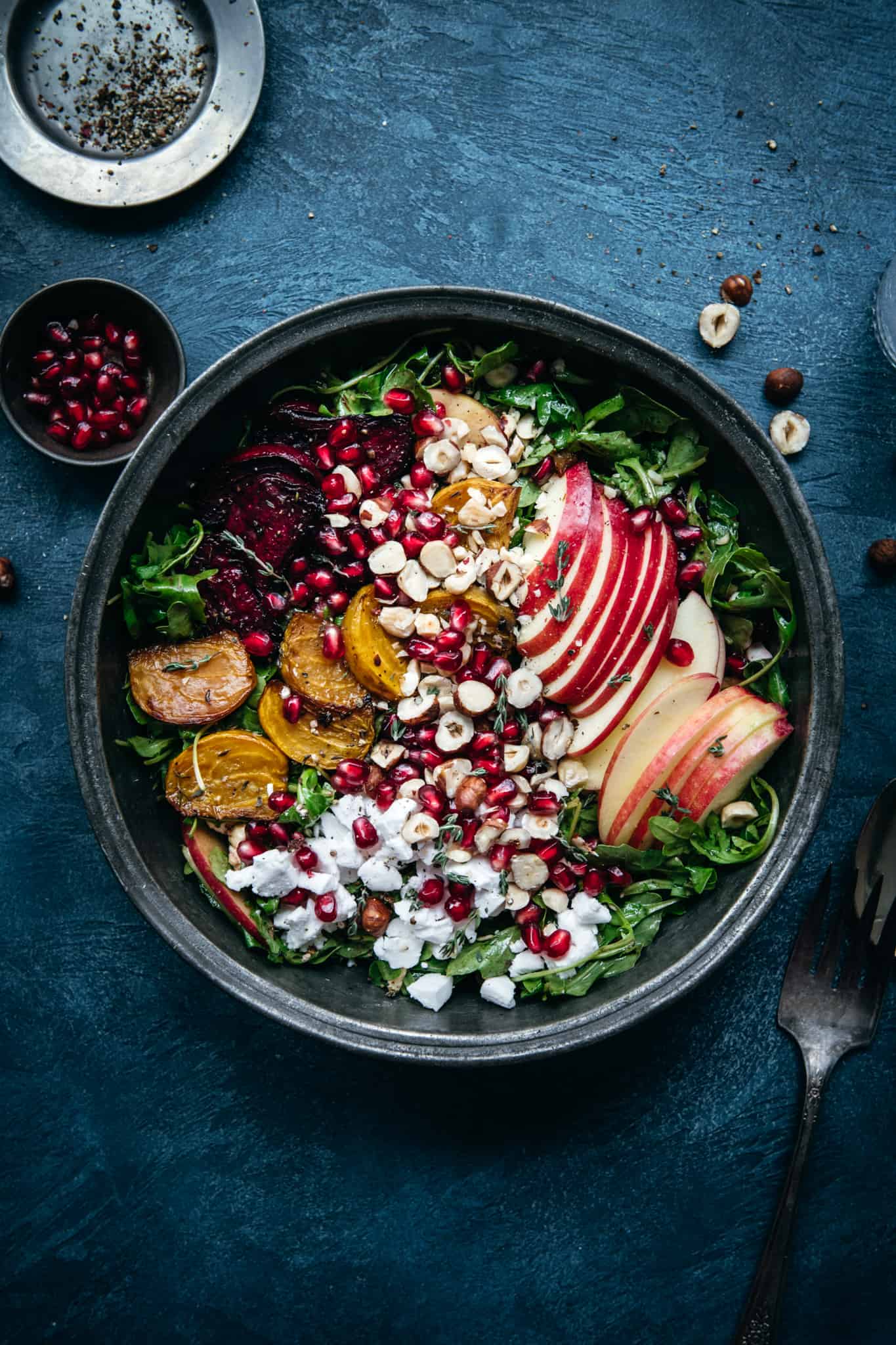 close up overhead view of roasted beet salad with vegan feta and kale