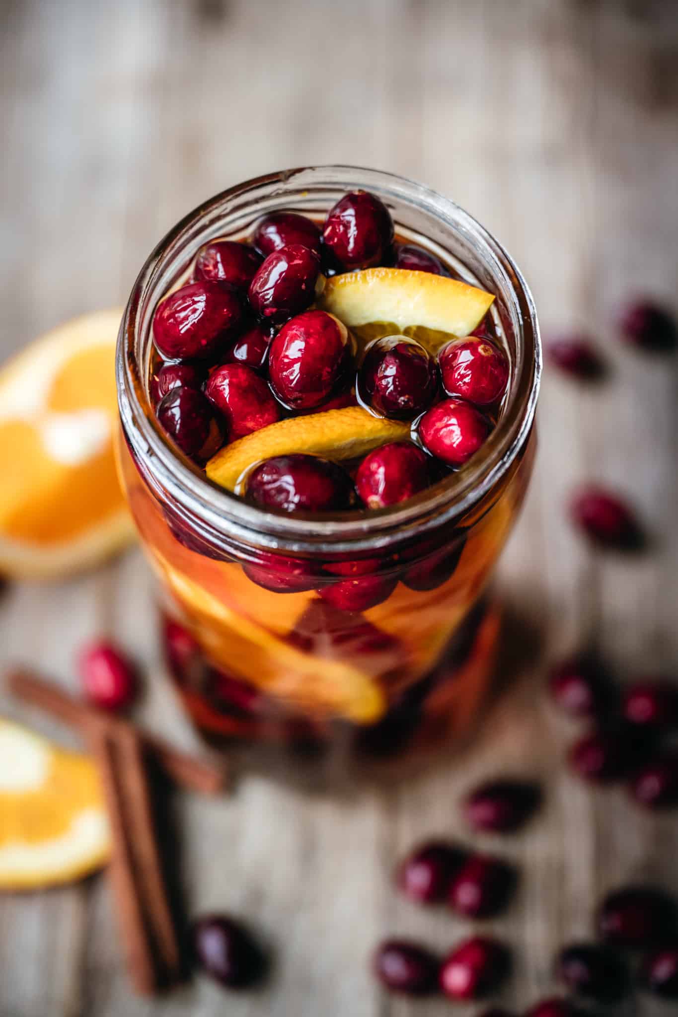 side view of cranberry orange infused whiskey