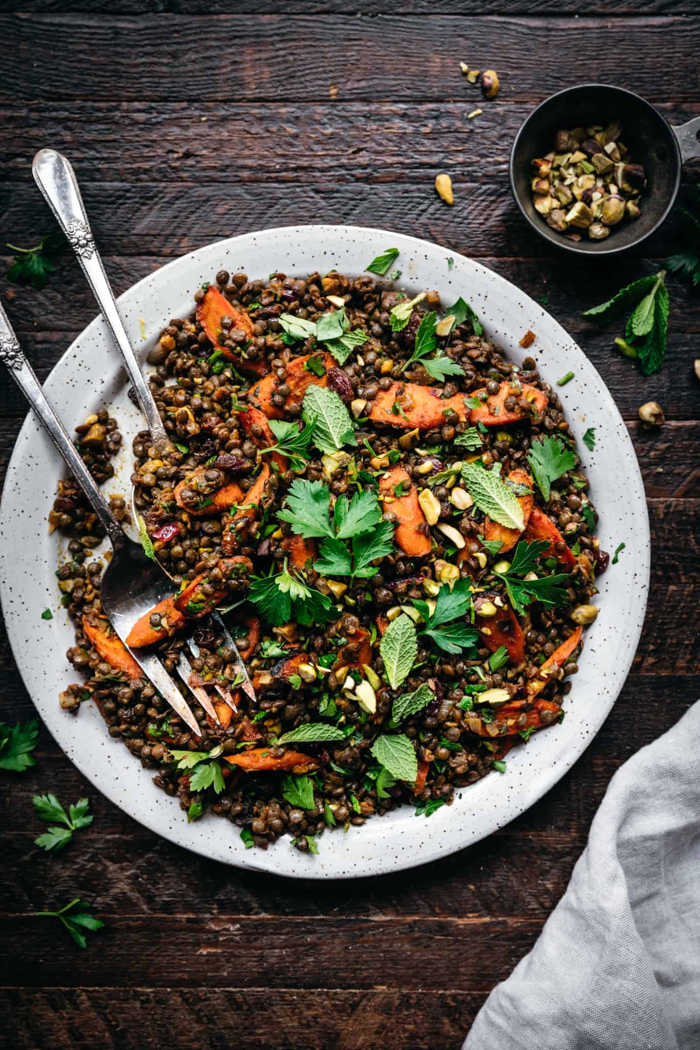 overhead view of moroccan lentil salad on a white plate with roasted carrots