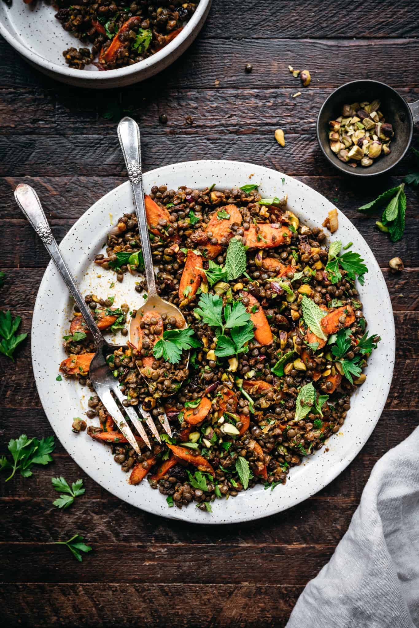 overhead view of vegan french lentil salad with roasted carrots on white plate