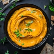 Roasted carrot dip seen from above in a bowl.