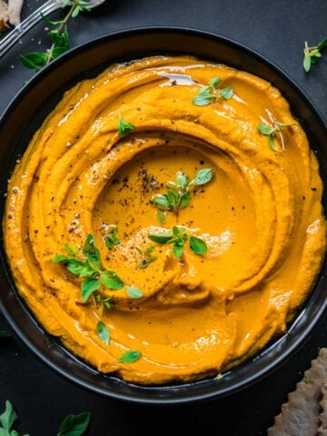 Roasted carrot dip seen from above in a bowl.