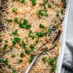 close up overhead of texture on a vegan spaghetti squash casserole with a spoon in the dish