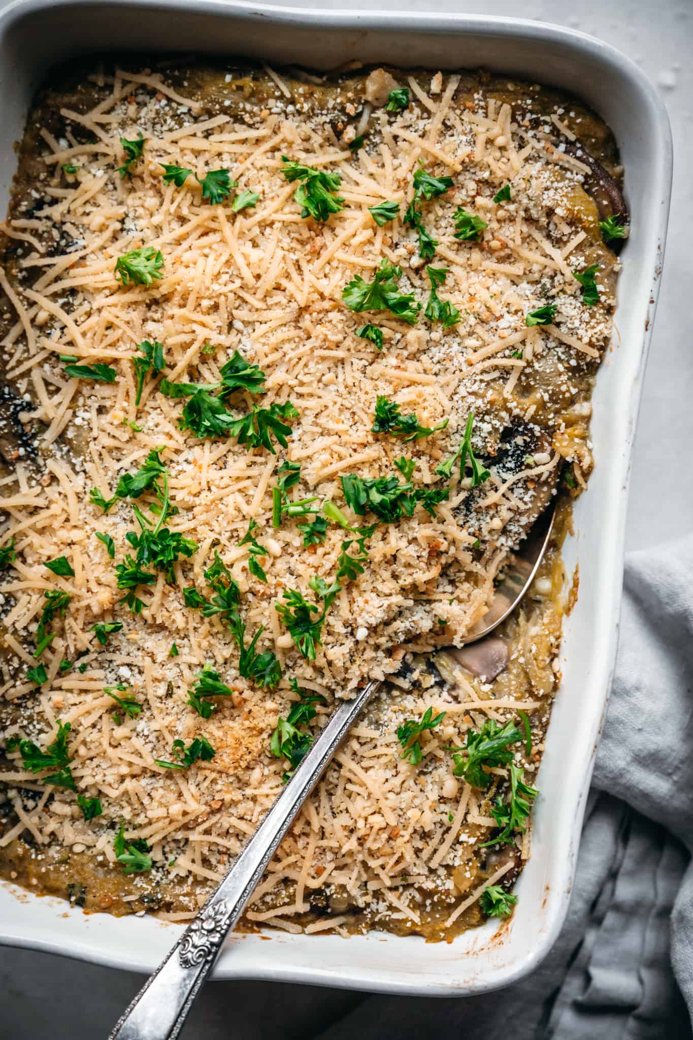 close up overhead of texture on a vegan spaghetti squash casserole with a spoon in the dish