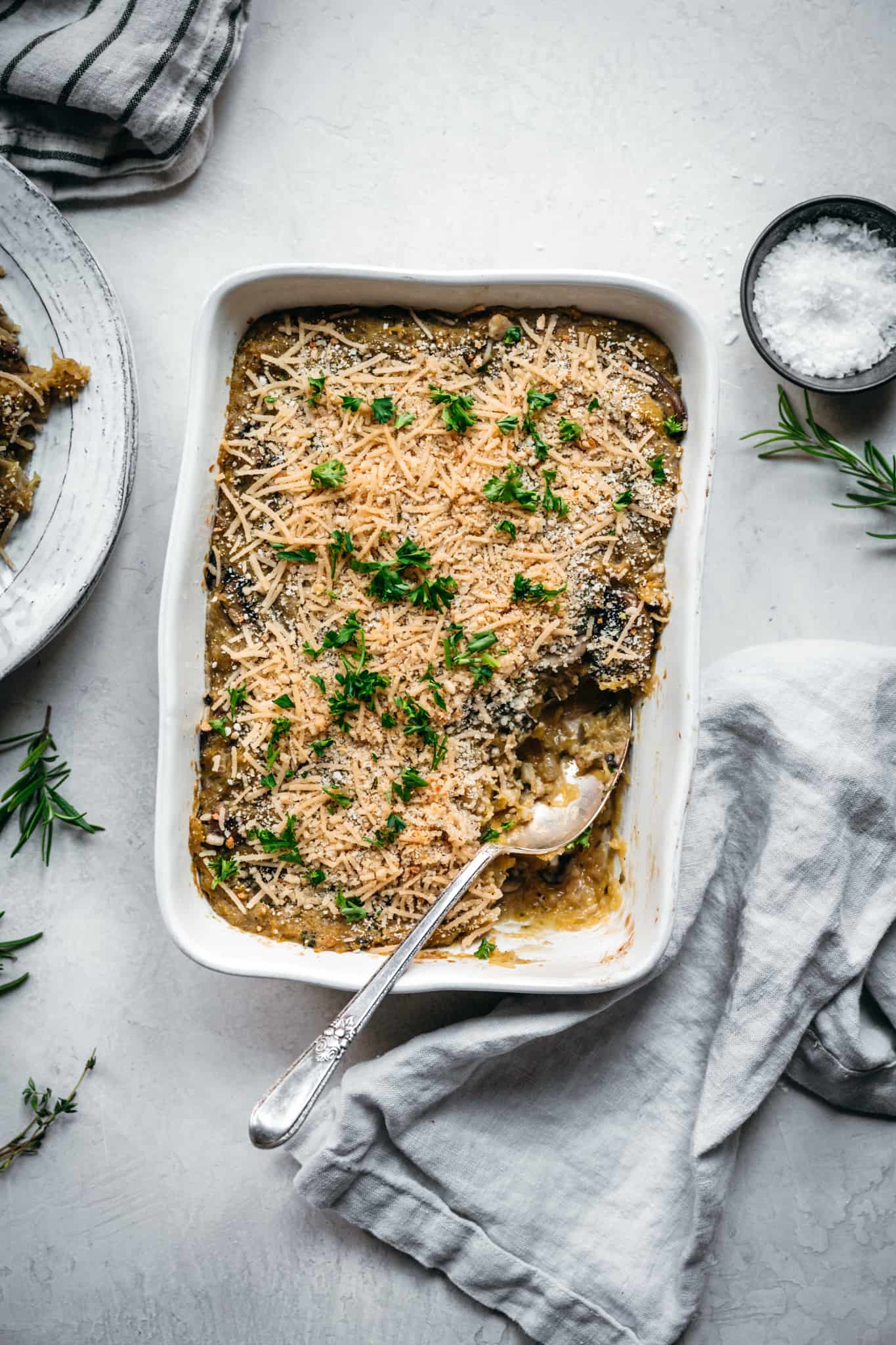 overhead view of baked vegan spaghetti squash casserole on white background