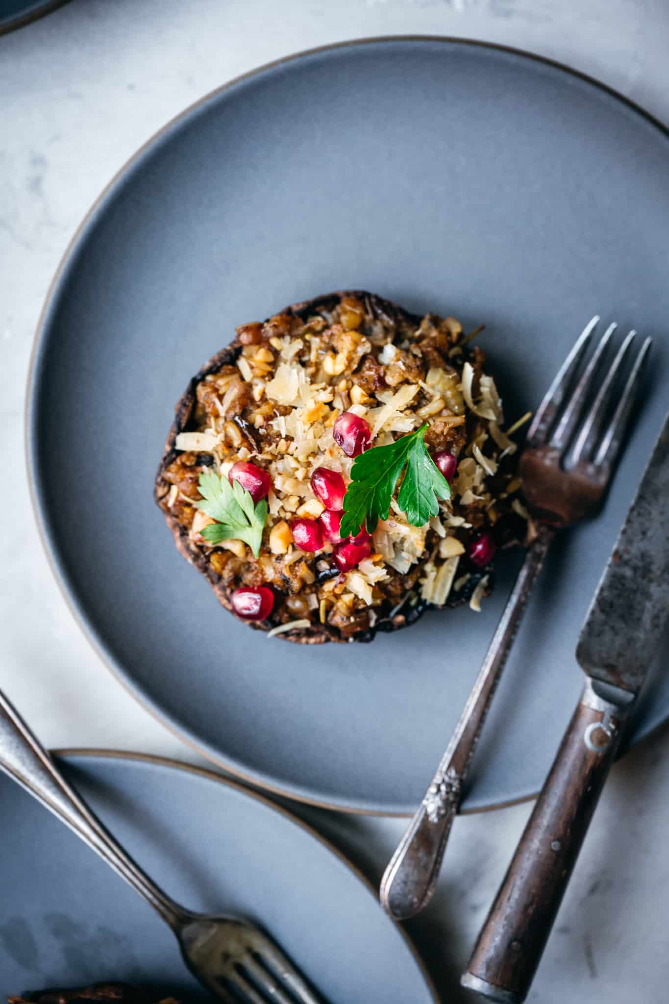 overhead of a vegan portobello mushroom on a blue plate