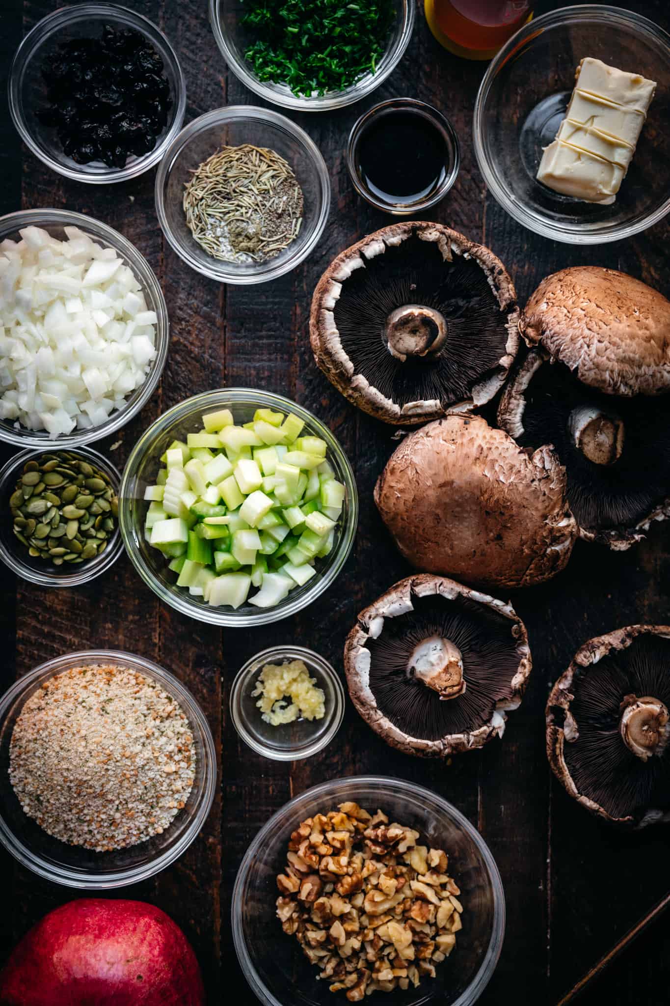 overhead view of ingredients for vegan stuffed portobello mushrooms on wood surface