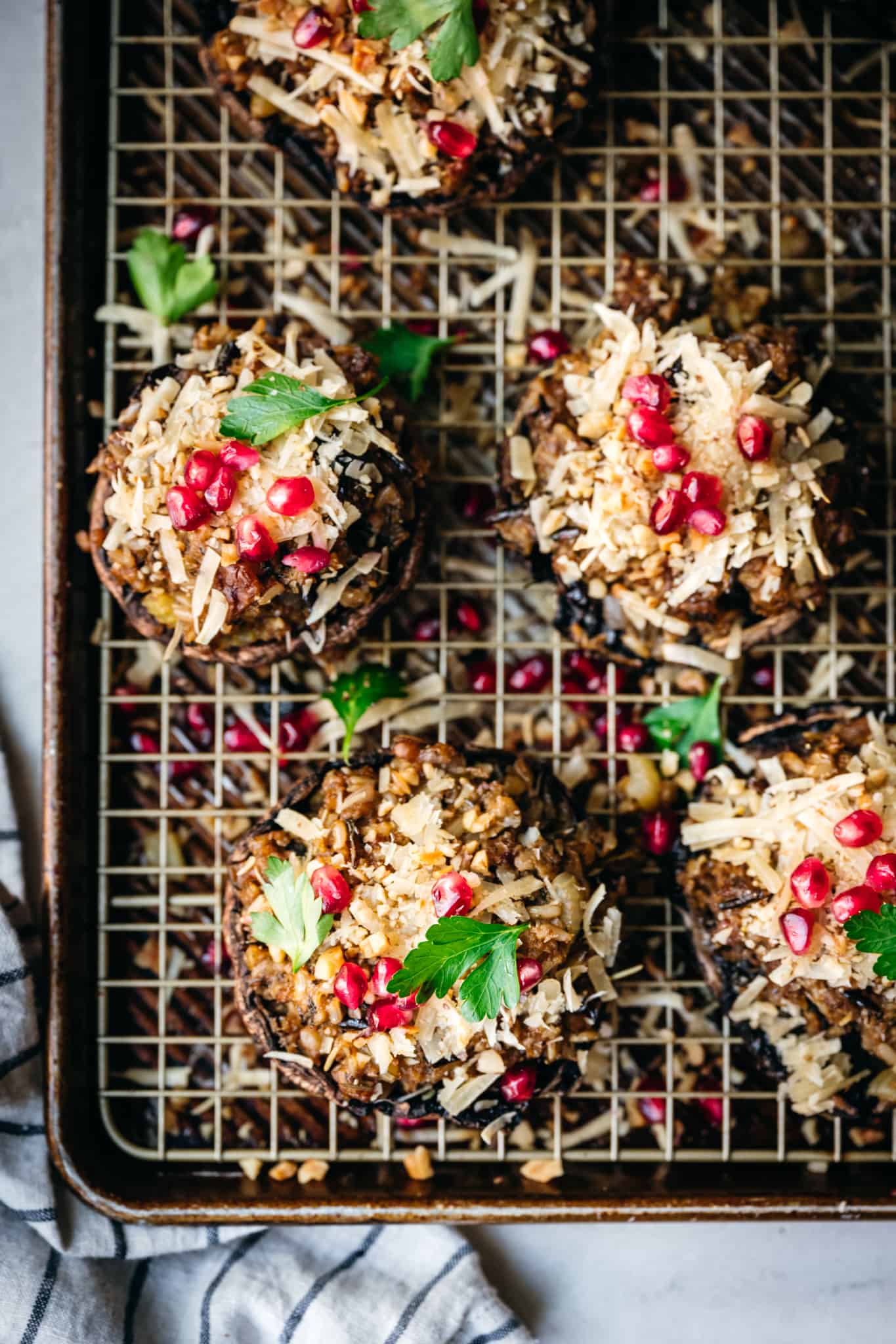 overhead of vegan stuffed portobello mushrooms on a wire rack over a baking sheet