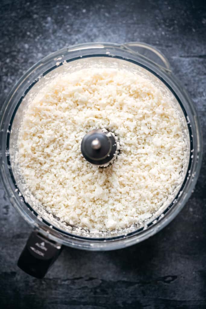overhead of cauliflower rice in a food processor