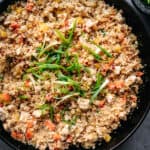 overhead of vegan cauliflower fried rice in a cast iron skillet