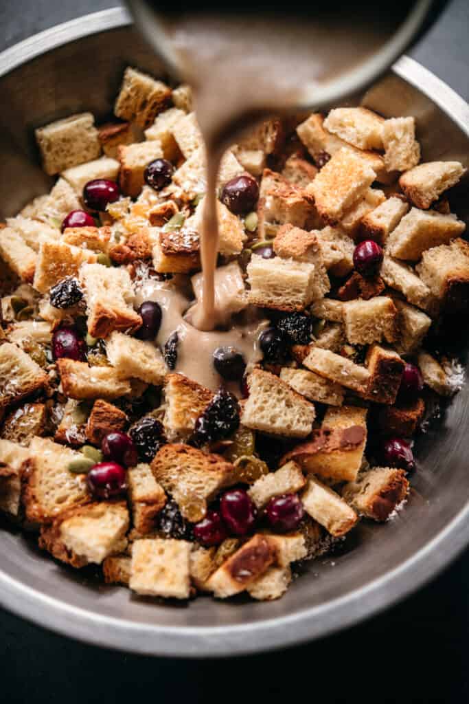 Pouring liquid into bread mixture for bread pudding
