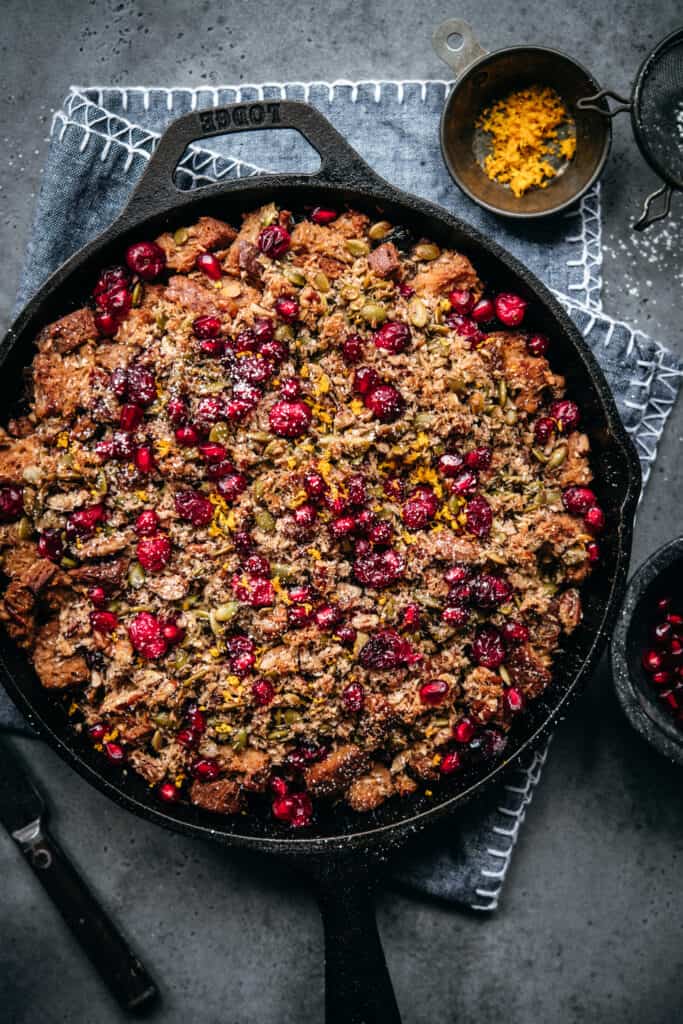 overhead view of gluten free cranberry cardamom bread pudding in skillet