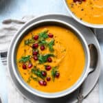 close up overhead of roasted golden beet soup with pomegranate seeds