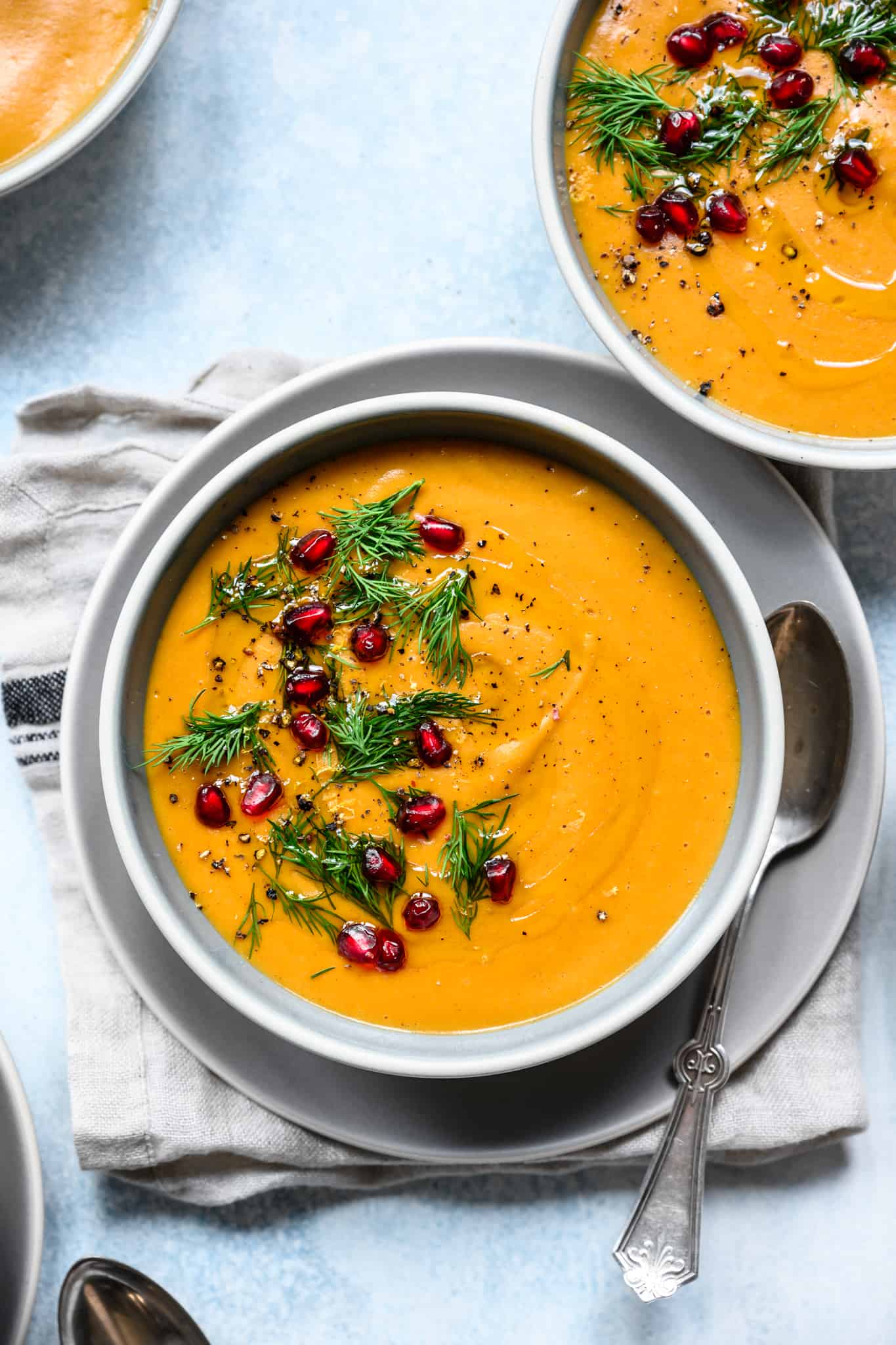 close up overhead of roasted golden beet soup with pomegranate seeds