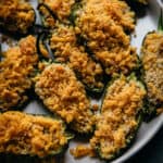 close up of vegan jalapeno poppers on a white plate