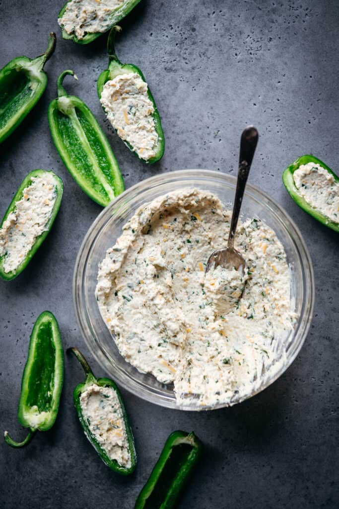 overhead of a bowl of vegan cheese filling for jalapeño peppers