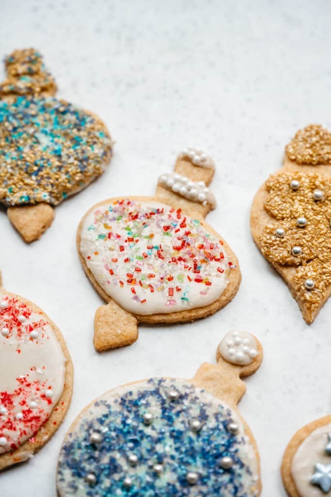 close up side view of vegan sugar cookies with icing and sprinkles