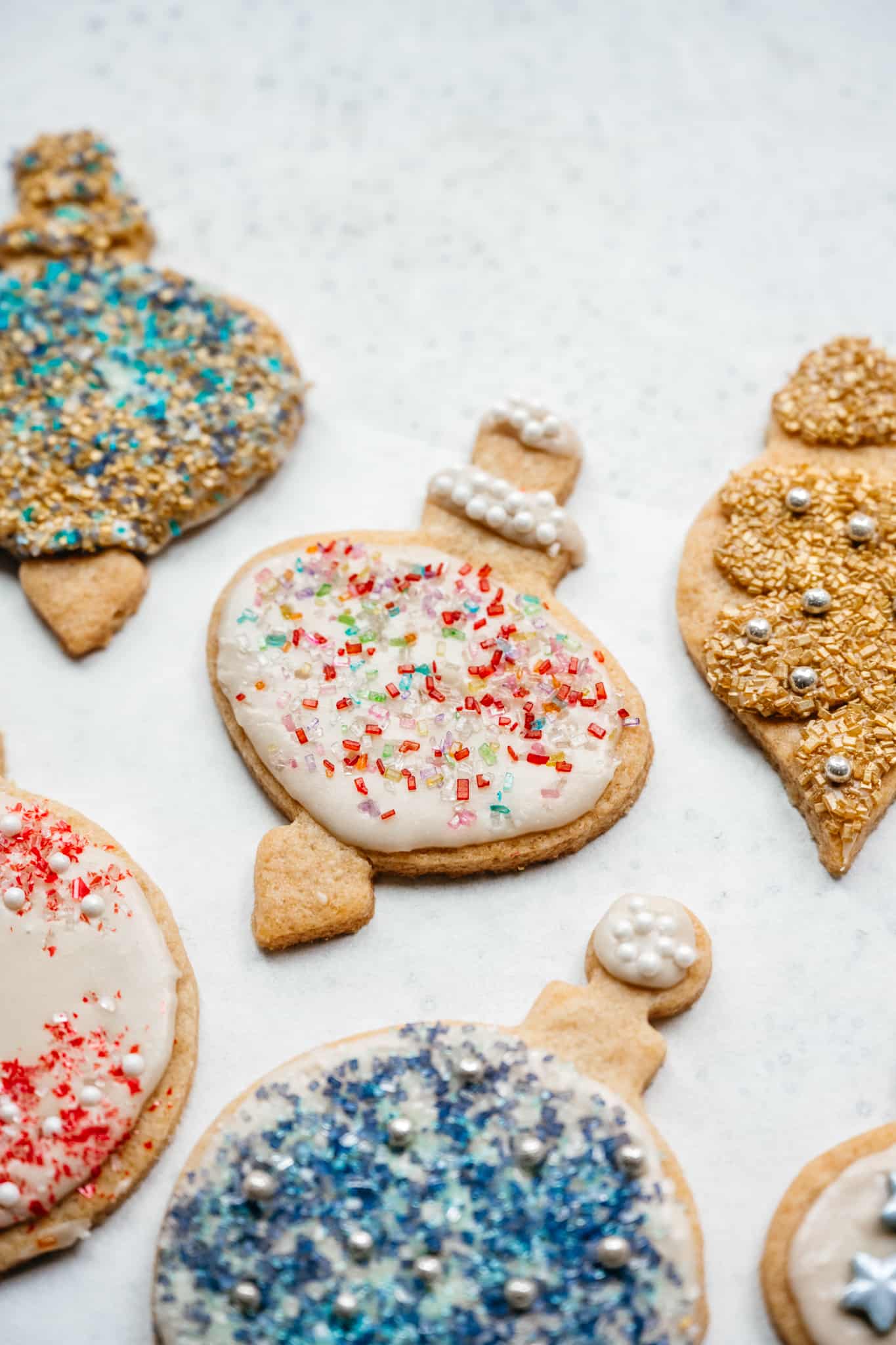 close up side view of vegan sugar cookies with icing and sprinkles