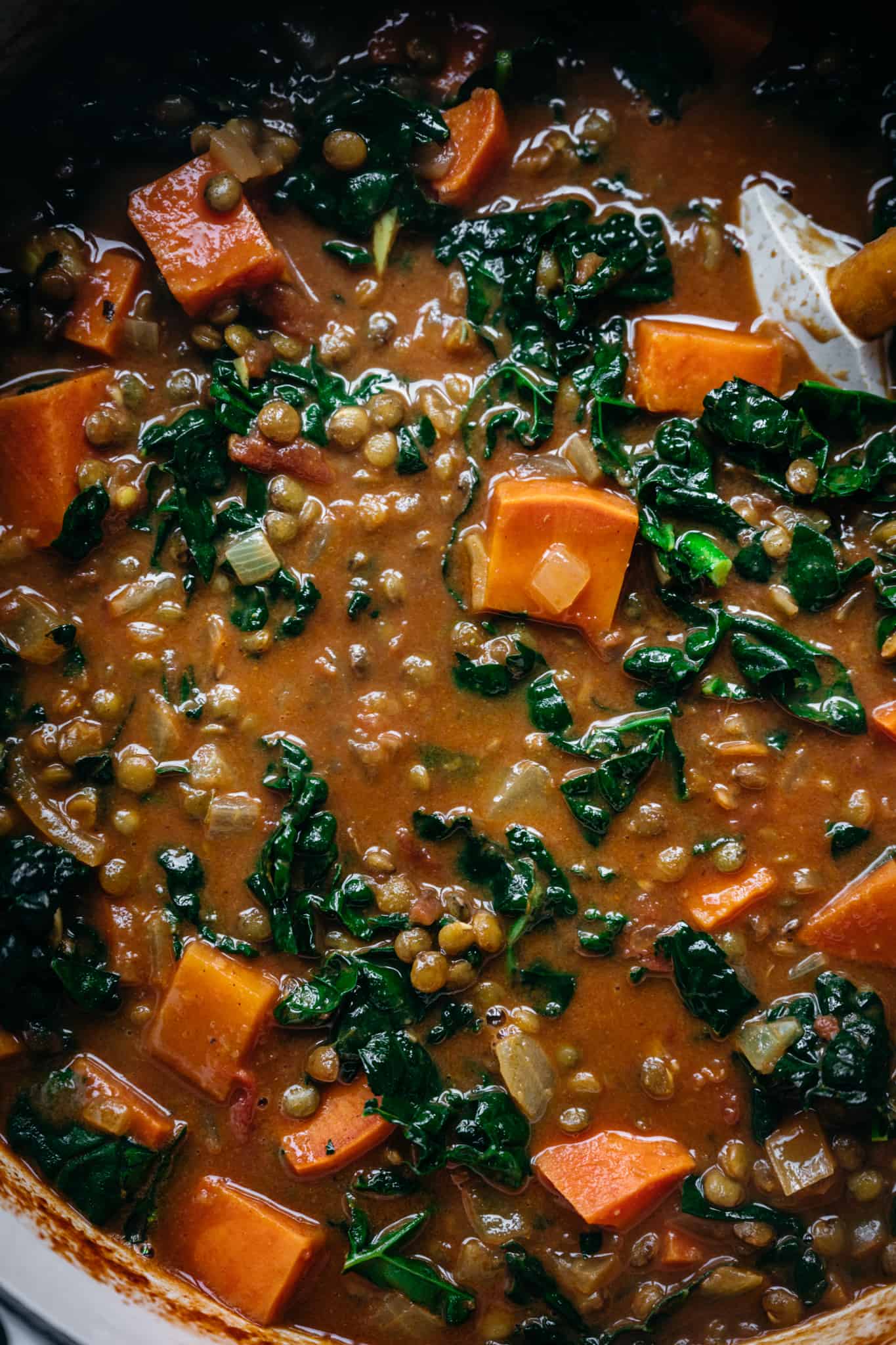 close up overhead view of vegan lentil curry sweet potato soup in pot