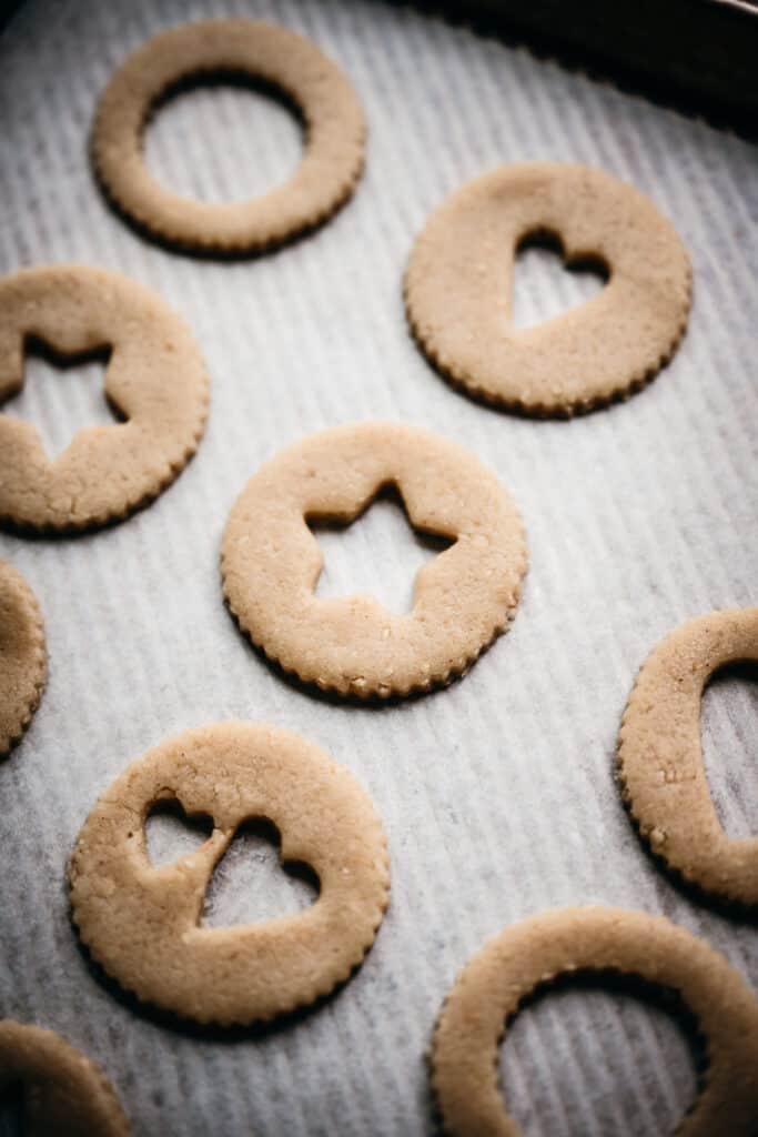 side view of unbaked linzer cookies on parchment paper
