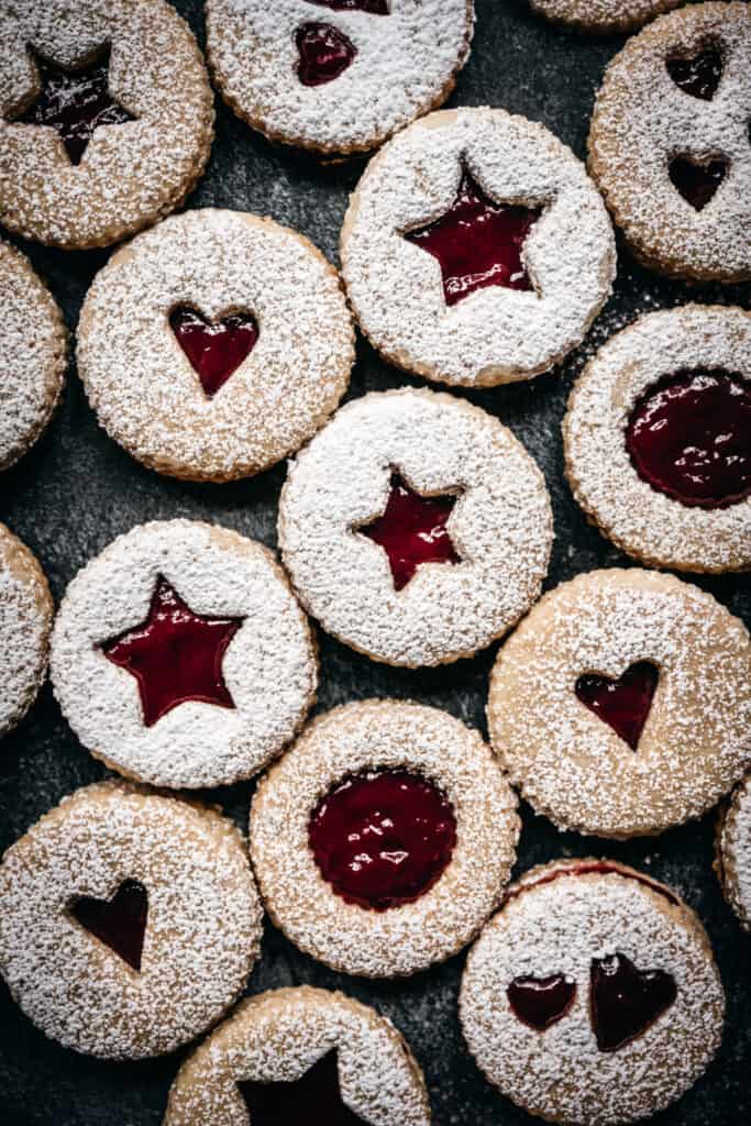 overhead view of vegan linzer cookies with powdered sugar on top