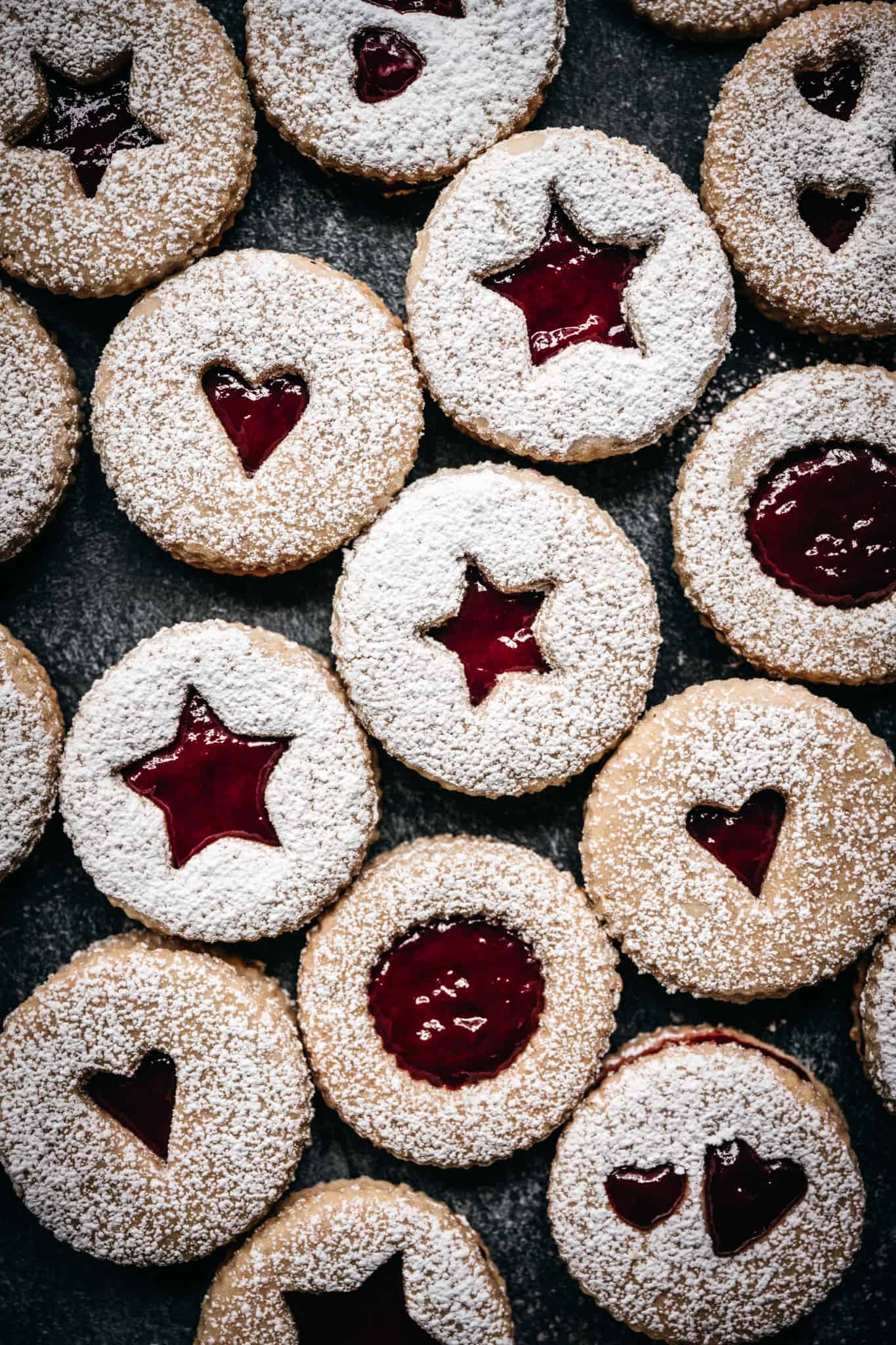 overhead view of vegan linzer cookies with powdered sugar on top