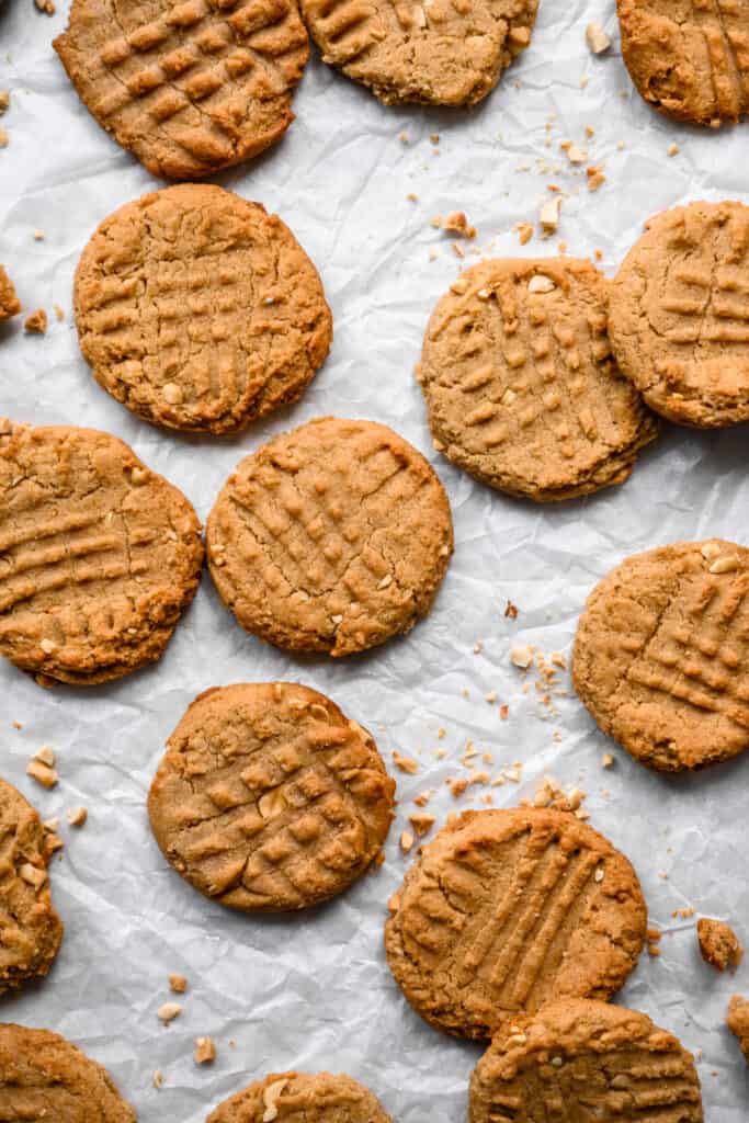 overhead view of vegan and gluten free peanut butter cookies on parchment paper