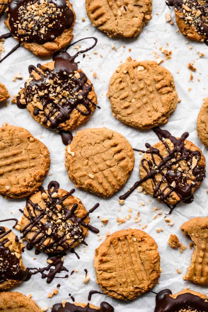 overhead view of peanut butter cookies with some drizzled in chocolate