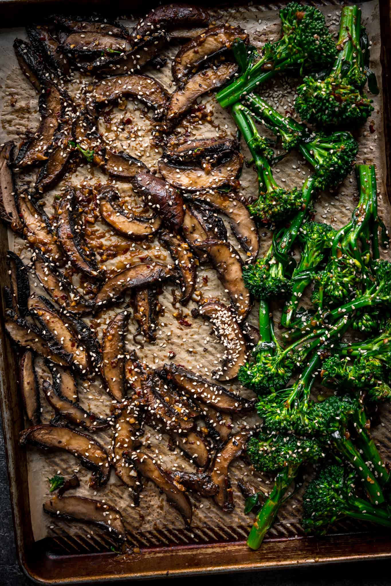 overhread of a sheet pan with mushrooms and broccolini