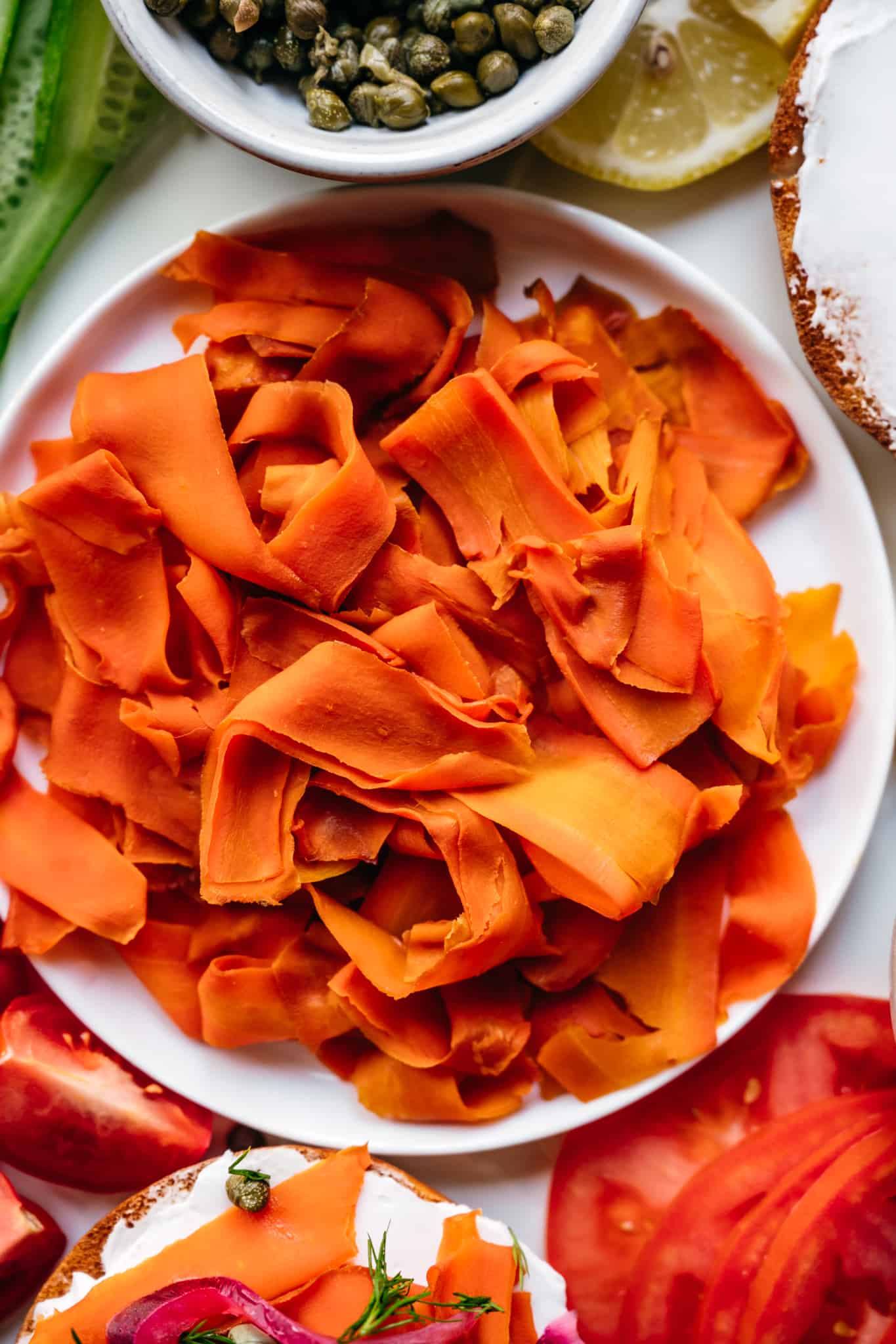 overhead of vegan carrot lox on a white plate